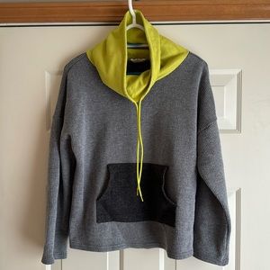 Soft grey pullover with drawstring collar and pocket.